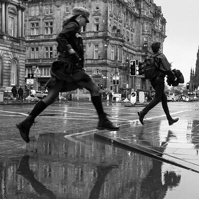 2 people jumping puddles for joy